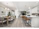 Spacious open floor plan with a dining area, kitchen island, and living room with lots of natural light at 21482 E 60Th Ave, Aurora, CO 80019