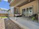Relaxing covered patio with cozy seating and decorative lighting, perfect for outdoor entertaining at 21482 E 60Th Ave, Aurora, CO 80019