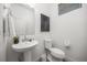 Bright powder room boasts a pedestal sink, modern fixtures, and a clean, minimalist design at 21482 E 60Th Ave, Aurora, CO 80019