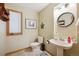 Charming powder room featuring a pedestal sink and rustic decor at 2397 Hearth Dr, Evergreen, CO 80439