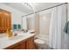 Well-lit bathroom features a sink, vanity and shower-tub combo with neutral tiling at 2397 Hearth Dr, Evergreen, CO 80439