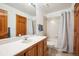 Standard bathroom featuring a vanity, a shower-tub combo, and neutral tiling at 2397 Hearth Dr, Evergreen, CO 80439