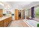 Spacious bathroom with double vanity, soaking tub, and a separate glass-enclosed shower at 2397 Hearth Dr, Evergreen, CO 80439