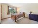 Cozy bedroom features a wooded view from the window and comfortable carpeted floor at 2397 Hearth Dr, Evergreen, CO 80439