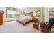 Bright bedroom with large windows, wood furnishings, and a comfortable bed at 2397 Hearth Dr, Evergreen, CO 80439