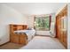 Cozy bedroom featuring a built-in bed frame, window view, and closet at 2397 Hearth Dr, Evergreen, CO 80439