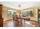 Comfortable dining room with hardwood floors and large windows overlooking a beautiful yard at 2397 Hearth Dr, Evergreen, CO 80439