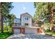 Charming two-story home with a well-maintained lawn, mature trees, and a two-car garage at 2397 Hearth Dr, Evergreen, CO 80439