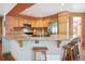 Well-equipped kitchen featuring granite countertops, stainless steel appliances, and a breakfast bar at 2397 Hearth Dr, Evergreen, CO 80439