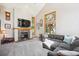 Cozy living room showcasing a stone fireplace and large windows with natural light at 2397 Hearth Dr, Evergreen, CO 80439