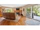 Comfortable living area featuring a fireplace, hardwood flooring, and easy access to the outdoors at 2397 Hearth Dr, Evergreen, CO 80439