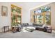 Bright living room featuring large windows and a comfortable gray sectional sofa at 2397 Hearth Dr, Evergreen, CO 80439