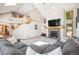Inviting living room featuring a fireplace, high ceilings, and plenty of natural light at 2397 Hearth Dr, Evergreen, CO 80439