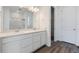 Modern bathroom features double vanity, large mirror, and a walk-in shower at 19100 E 96Th Pl, Commerce City, CO 80022