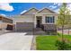 Charming single-story home with stone accents, landscaped front yard, and attached two-car garage at 19100 E 96Th Pl, Commerce City, CO 80022
