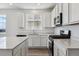 Stylish kitchen with white cabinets, stainless steel appliances, and elegant countertops at 19100 E 96Th Pl, Commerce City, CO 80022
