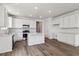 Spacious kitchen boasts white cabinets, stainless steel appliances, and a center island at 19100 E 96Th Pl, Commerce City, CO 80022