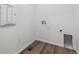 Practical laundry area with modern wood-look floors and connections for washer and dryer at 19100 E 96Th Pl, Commerce City, CO 80022