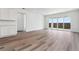 Open concept living room with modern flooring and sliding glass doors for outdoor access at 19100 E 96Th Pl, Commerce City, CO 80022