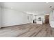 Open-concept space with wood floors, white walls, and ample natural light in a modern style at 19100 E 96Th Pl, Commerce City, CO 80022