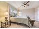 Bright bedroom featuring a ceiling fan, large windows, and a cozy bed with ample natural light at 3912 Ute Mountain Trl, Castle Rock, CO 80109