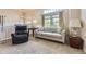 Cozy living space with a large window, sofa, and easy chair for relaxing and unwinding at 3912 Ute Mountain Trl, Castle Rock, CO 80109