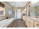 This primary bathroom features a glass shower, soaking tub, tile floors, and a granite vanity at 15995 Humboldt Peak Dr, Broomfield, CO 80023