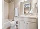 This full bathroom features a shower-tub combo with a white vanity and toilet at 15995 Humboldt Peak Dr, Broomfield, CO 80023