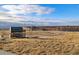 Modern school building with welcoming signage, set against a backdrop of open fields and a blue, cloudy sky at 15995 Humboldt Peak Dr, Broomfield, CO 80023