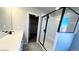 Bright bathroom with a glass-enclosed shower, quartz counters, and a walk-in closet at 16830 Mckay Dr, Mead, CO 80542