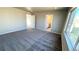 Neutral bedroom with plush carpet and large window, leading to the ensuite bathroom at 16830 Mckay Dr, Mead, CO 80542