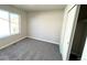 Bedroom with carpeted floor, large window, and closet at 16830 Mckay Dr, Mead, CO 80542