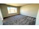 Bedroom featuring neutral walls, plush carpet, and a large window at 16830 Mckay Dr, Mead, CO 80542