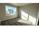 Bedroom with carpeted floor, a large window overlooking the neighborhood, and a closet at 16830 Mckay Dr, Mead, CO 80542