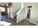 Bright entryway boasts wood floors, a staircase, and a convenient powder room at 16830 Mckay Dr, Mead, CO 80542