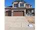 Two-story house with brown garage doors and a landscaped front yard at 16830 Mckay Dr, Mead, CO 80542