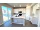 Stylish kitchen featuring white cabinetry, a center island, and sliding glass door to the yard at 16830 Mckay Dr, Mead, CO 80542