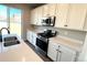 Bright kitchen with white cabinets, quartz countertops, and stainless steel appliances at 16830 Mckay Dr, Mead, CO 80542