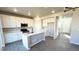 Modern kitchen features white cabinets, gray island, stainless appliances, and wood floors at 16830 Mckay Dr, Mead, CO 80542