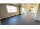 Open concept living space with wood flooring and access to the kitchen and backyard at 16830 Mckay Dr, Mead, CO 80542