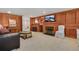Finished basement with fireplace, wood paneling, and comfortable seating at 675 Dahlia St, Denver, CO 80220