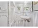 Classic white bathroom with shower/tub combo, and pedestal sink at 675 Dahlia St, Denver, CO 80220