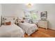 Cozy bedroom featuring two beds, hardwood floors, and natural light at 675 Dahlia St, Denver, CO 80220