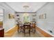 Elegant dining area with hardwood floors, built-in shelving, and French doors for outdoor access at 675 Dahlia St, Denver, CO 80220