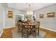 Bright dining room featuring hardwood floors, elegant wall decor, and views into the living room at 675 Dahlia St, Denver, CO 80220