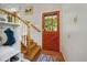 Inviting entryway with stairs, coat rack, and a wooden front door at 675 Dahlia St, Denver, CO 80220