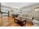 Open-concept kitchen and living area with hardwood floors and lots of natural light at 675 Dahlia St, Denver, CO 80220