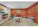 Spacious playroom with wood paneling and organized storage at 675 Dahlia St, Denver, CO 80220