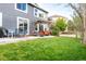 Large backyard with patio spaces, a lush lawn, and mature trees offering a relaxing outdoor space at 5910 W Sumac Ave, Littleton, CO 80123