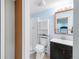Basement bathroom features a glass shower, vanity with sink, and toilet at 5910 W Sumac Ave, Littleton, CO 80123